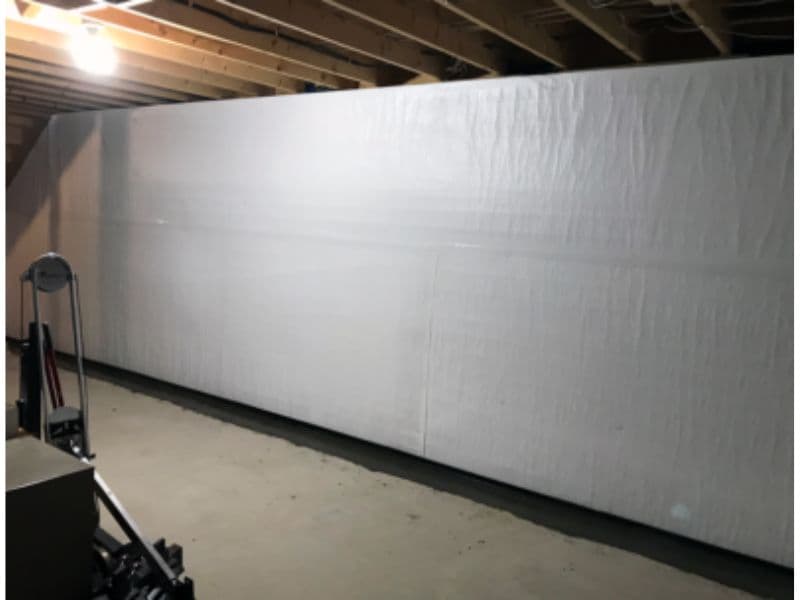 A basement wall finished with a waterproof encapsulation liner